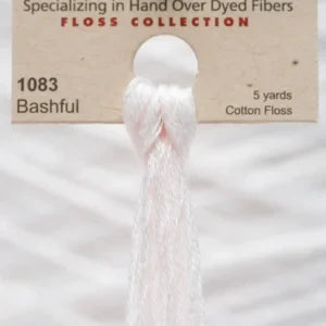 Skein of cotton floss labeled '1083 Bashful' with a beige background.