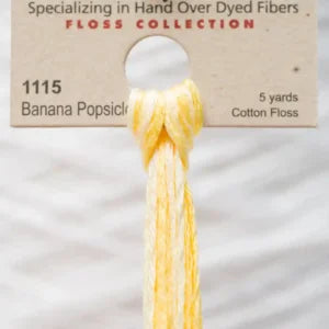 Variegated yellow skein of cotton floss labeled '1115 Banana Popsicle' by Weeks Dye Works