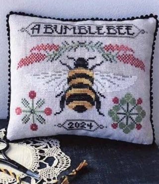 A Bumblebee cross stitch pattern with a bee, floral sprigs, berries, and decorative text by A Gardener’s Needle