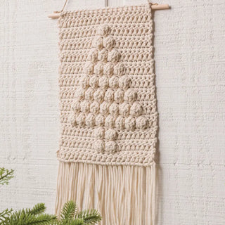 Macrame wall hanging with a textured pattern on a light background