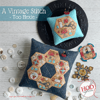 Cross-stitch design featuring multiple hexagon motifs filled with floral and geometric patterns, arranged in a patchwork-style layout and finished as decorative pincushions.