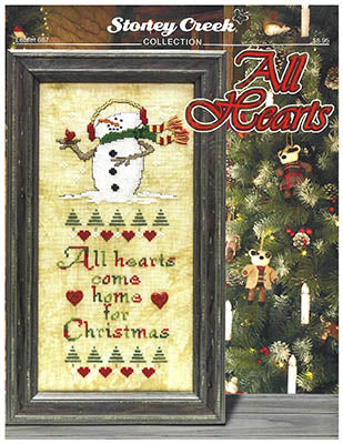 Stoney Creek cross-stitch pattern book titled 'All Hearts' with a snowman design and Christmas tree in the background.