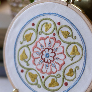 Embroidery hoop with a floral design on white fabric