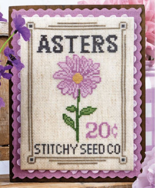 Cross-stitched design of a purple aster flower with text 'ASTERS' and 'STITCHY SEED CO' on a white background.