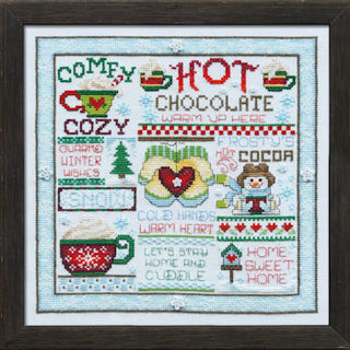 Cross-stitched design of hot chocolate-themed text and graphics with a snowy scene.
