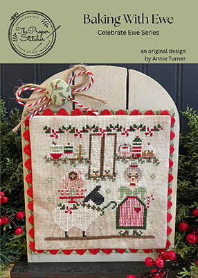 Cross-stitched design with festive elements on a wooden board, surrounded by red berries and greenery.