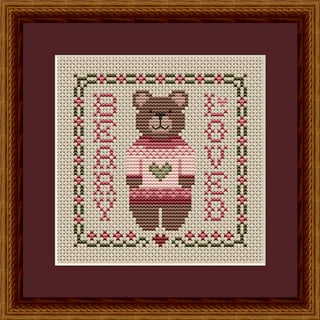 Cross-stitched bear with a heart on a framed background