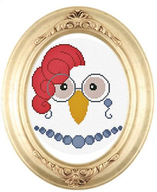 Cross-stitched portrait of a whimsical hen with round glasses, a red feather hairstyle, and a blue beaded necklace, displayed in an ornate oval gold frame.