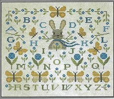 Sampler with alphabet and butterfly designs on a light background