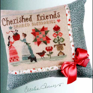 Cross-stitched pillow with 'Cherished Friends' text and decorative elements, featuring Heart in Hand Needleworks branding.