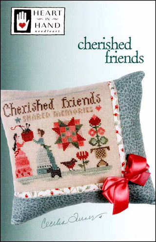 Cross-stitched pillow with 'Cherished Friends' text and decorative elements, featuring Heart in Hand Needleworks branding.