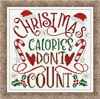 Cross-stitched Christmas design featuring swirling typography reading “Christmas Calories Don’t Count,” decorated with candy canes, Santa hats, holly, and hearts in red, green, and brown on white fabric with a festive border.