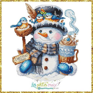 Cross stitch design of a cheerful snowman with a plaid scarf, cocoa mug, bluebirds on his hat, and a “Christmas Cheer” sign framed in a golden border.