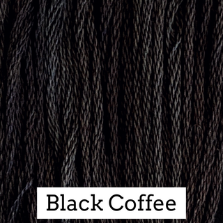 Close-up of black coffee embroidery floss with a label indicating the color.