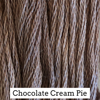Close-up of twisted embroidery floss strands in a warm chocolate cream brown color, with a white label at the bottom reading 'Chocolate Cream Pie'.