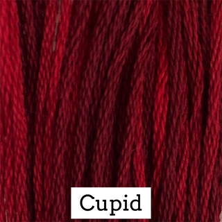 Close-up of red embroidery thread with 'Cupid' label