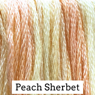 Close-up of peach sherbet embroidery floss with a label indicating the color name.