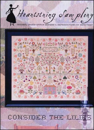 Cross stitch sampler featuring floral motifs, animals, a central house, and the verse, "Consider the lilies of the field, they neither toil nor spin." Designed by Heartstring Samplery.