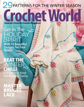 Crochet World magazine cover with a crocheted blanket and text about winter patterns and holiday spirit.