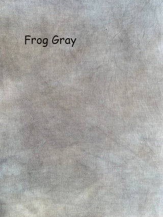 A close-up fabric texture swatch labeled 'Frog Gray' in black text, showing a mottled light gray material with subtle beige and off-white variation.
