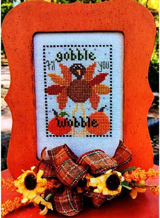 Gobble ’Til You Wobble cross stitch design by Val’s Stuff featuring a bright turkey with autumn feathers, pumpkins, and playful Thanksgiving lettering.