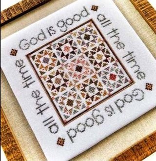 Cross-stitched design with text 'God is good all the time' on a white background.