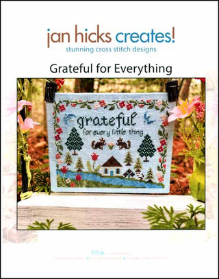 Cross-stitch design featuring the phrase “grateful for every little thing” surrounded by birds, squirrels, florals, and nature motifs within a scalloped floral border.