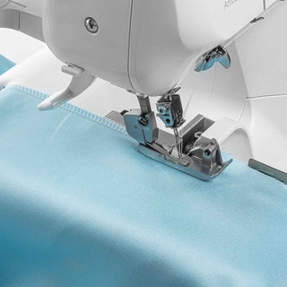 Serger machine needle stitching blue fabric