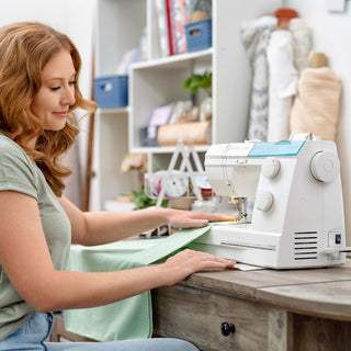 Woman using a sewing machine in a home setting