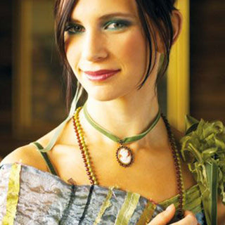 Woman wearing a necklace with a pendant in an outdoor setting