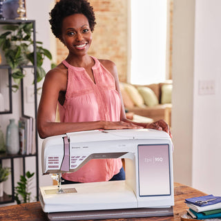 Woman holding a sewing machine in a home setting