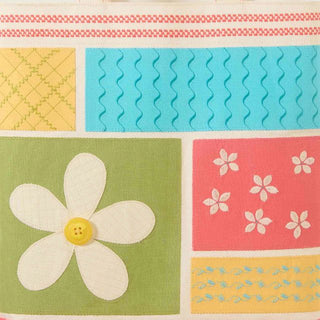 Colorful quilt with floral patterns and a large daisy on a green square.