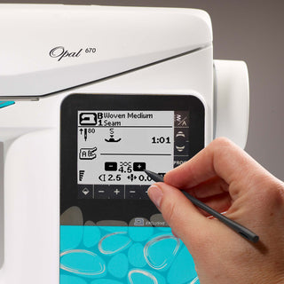 Opal sewing machine with digital display and hand using a pen to interact with the screen