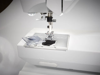 Close-up of a sewing machine on a white background