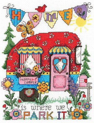 Cross-stitched design of a camper with colorful text and flowers