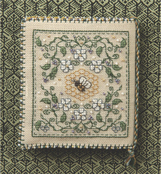 Decorative needlepoint with floral design on a green patterned background