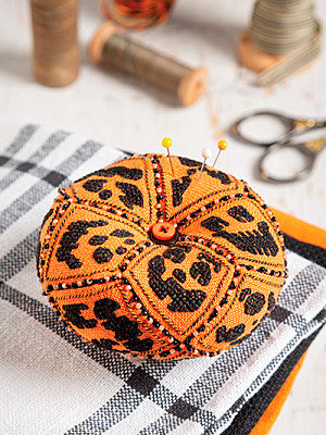 Just CrossStitch Magazine: 2025 Summer Edition. Jack-O'-Lantern Jumble
Design by Kim Beamish
The multiple carved-pumpkin faces of this spooky-yet-fun accessory will add a festive touch to your crafting space.