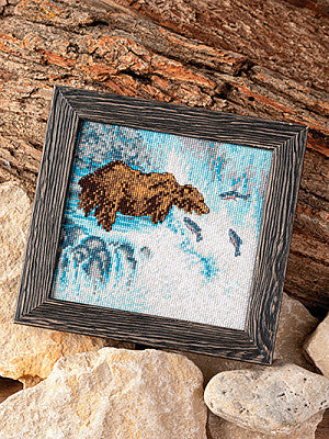 Just CrossStitch Magazine: 2025 Summer Edition. Waterfall Fishing
Original artwork by Jesse Schofield, adapted for cross stitch by Jesse Schofield.
Each year, many fish species migrate upstream, providing vital nourishment to other wildlife. Inspired by this natural phenomenon, Jesse Schofield painted this breathtaking scene, capturing a waterfall's misty beauty and now offers an adaptation of the work for cross stitch.