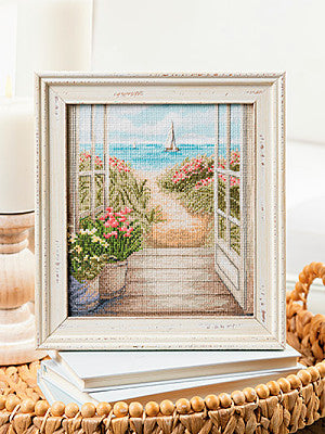Just CrossStitch Magazine: 2025 Summer Edition. Waterfront View
Artwork adapted for cross stitch by Les Petites Croix de Lucie.
Let this tranquil beach scene, with its bending seagrass and sweeping views, gently whisk you away to thoughts of sun-kissed days along the ocean.