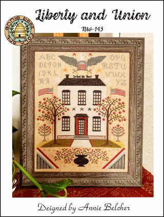 Framed sampler with house design and text, featuring the title 'Liberty and Union' and designer's name, Annie Belcher from Annie Beez Folk Art.