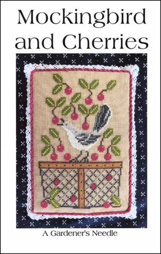 Cross-stitched design of a mockingbird and cherries on a book cover titled 'Mockingbird and Cherries'.