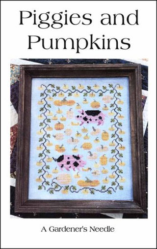 Cover of Piggie and Pumpkins Cross Stitch Pattern by A Gardener's Needle featuring a framed cross-stitch pattern stitched on light blue fabric with  pigs and pumpkins on a white background