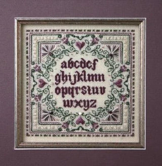 Embroidered sampler with alphabet and floral patterns on a purple background
