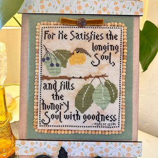 Psalm Bird cross stitch pattern by Luhu Stitches featuring a small bird on a branch with leaves and berries alongside the scripture Psalm 107:9.