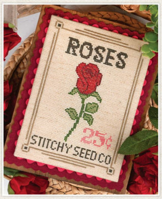 Cross-stitched card with a red rose and 'Stitchy Seed Co.' branding on a textured background.