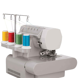 Sewing machine with colorful thread spools on a white background