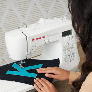 Singer sewing machine with a person using it on a white background