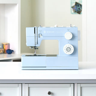 SINGER® Heavy Duty 4423 Meltwater Blue – displayed on sewing workspace