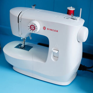 Singer sewing machine on a blue background
