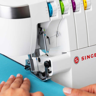 Singer sewing machine in use with blue fabric